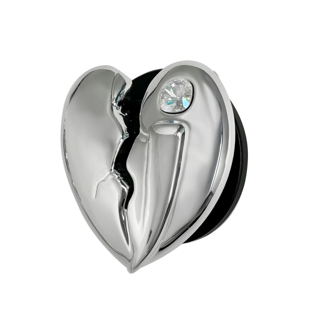 3D silver, pink, red and black metallic Phone grip featuring a cracked heart design with smooth chrome finish and a single embedded gem.