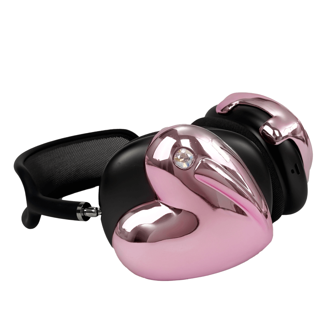 Metallic heart-shaped AirPods Max cover in silver, pink, red and black, with a smooth 3D sculpted surface and a single crystal stud detail.