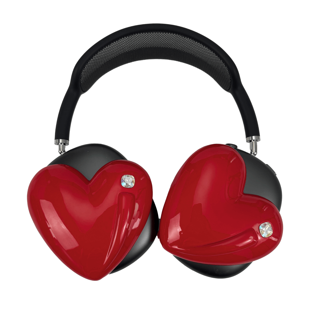 Metallic heart-shaped AirPods Max cover in silver, pink, red and black, with a smooth 3D sculpted surface and a single crystal stud detail.