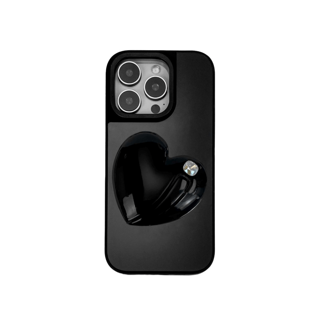 Metallic silver, pink, red, black iPhone case with a large sculpted heart in 3D, featuring a shiny chrome finish and a single gem-like detail.