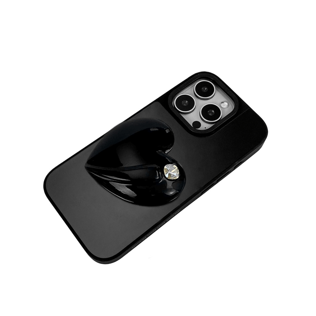 Metallic silver, pink, red, black iPhone case with a large sculpted heart in 3D, featuring a shiny chrome finish and a single gem-like detail.