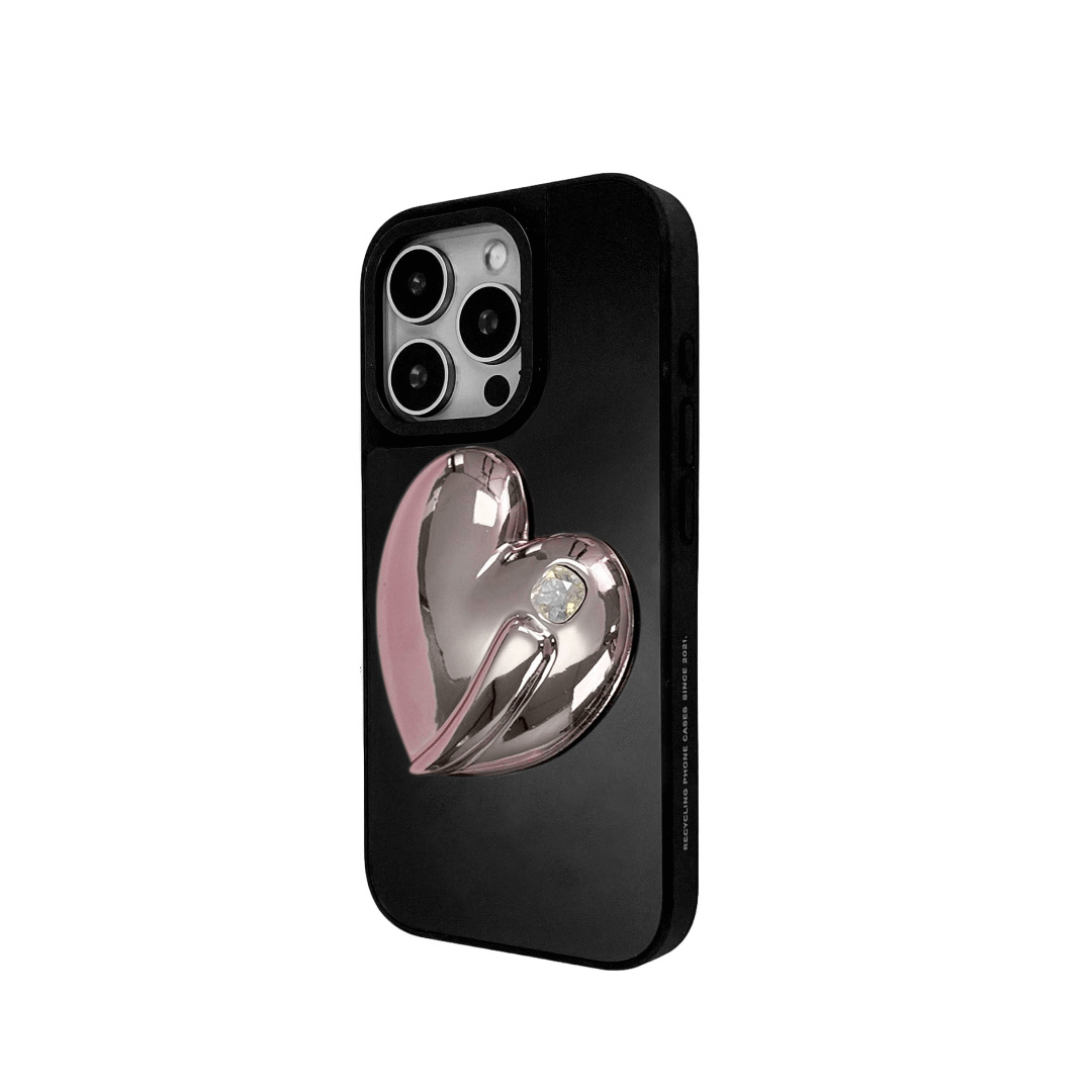 Metallic silver, pink, red, black iPhone case with a large sculpted heart in 3D, featuring a shiny chrome finish and a single gem-like detail.