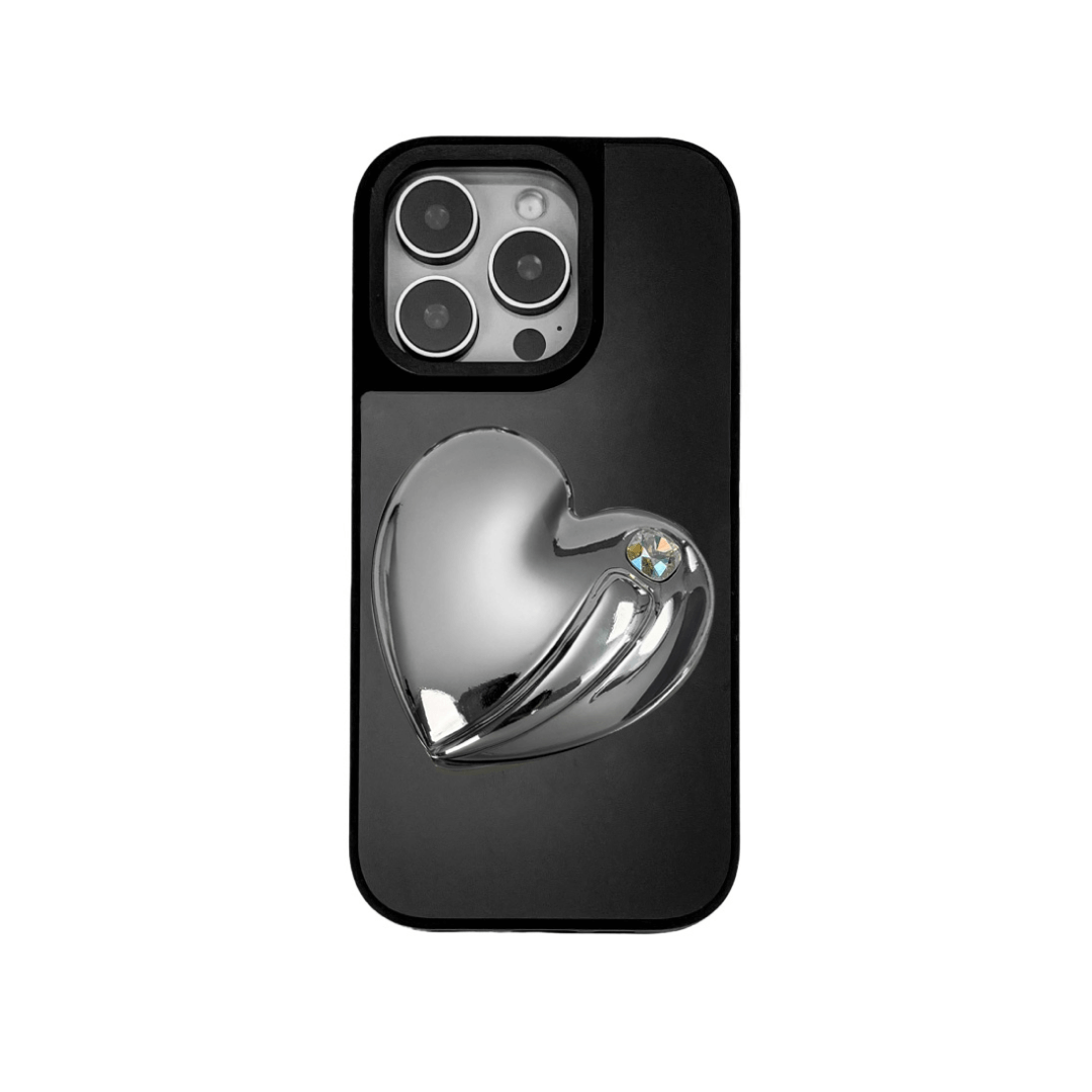 Metallic silver, pink, red, black iPhone case with a large sculpted heart in 3D, featuring a shiny chrome finish and a single gem-like detail.