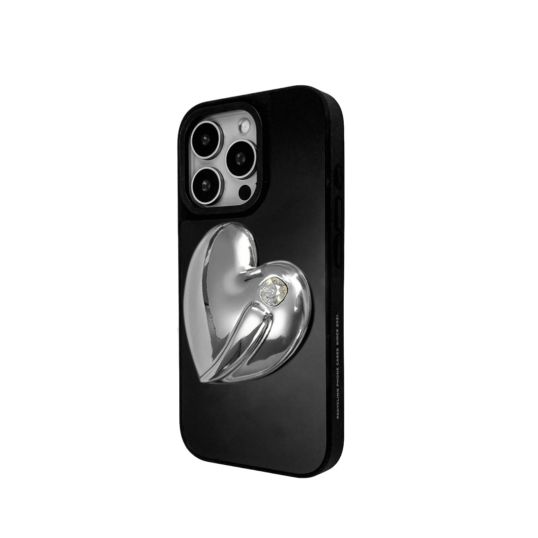 Metallic silver, pink, red, black iPhone case with a large sculpted heart in 3D, featuring a shiny chrome finish and a single gem-like detail.