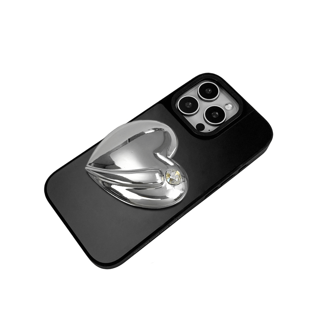 Metallic silver, pink, red, black iPhone case with a large sculpted heart in 3D, featuring a shiny chrome finish and a single gem-like detail.