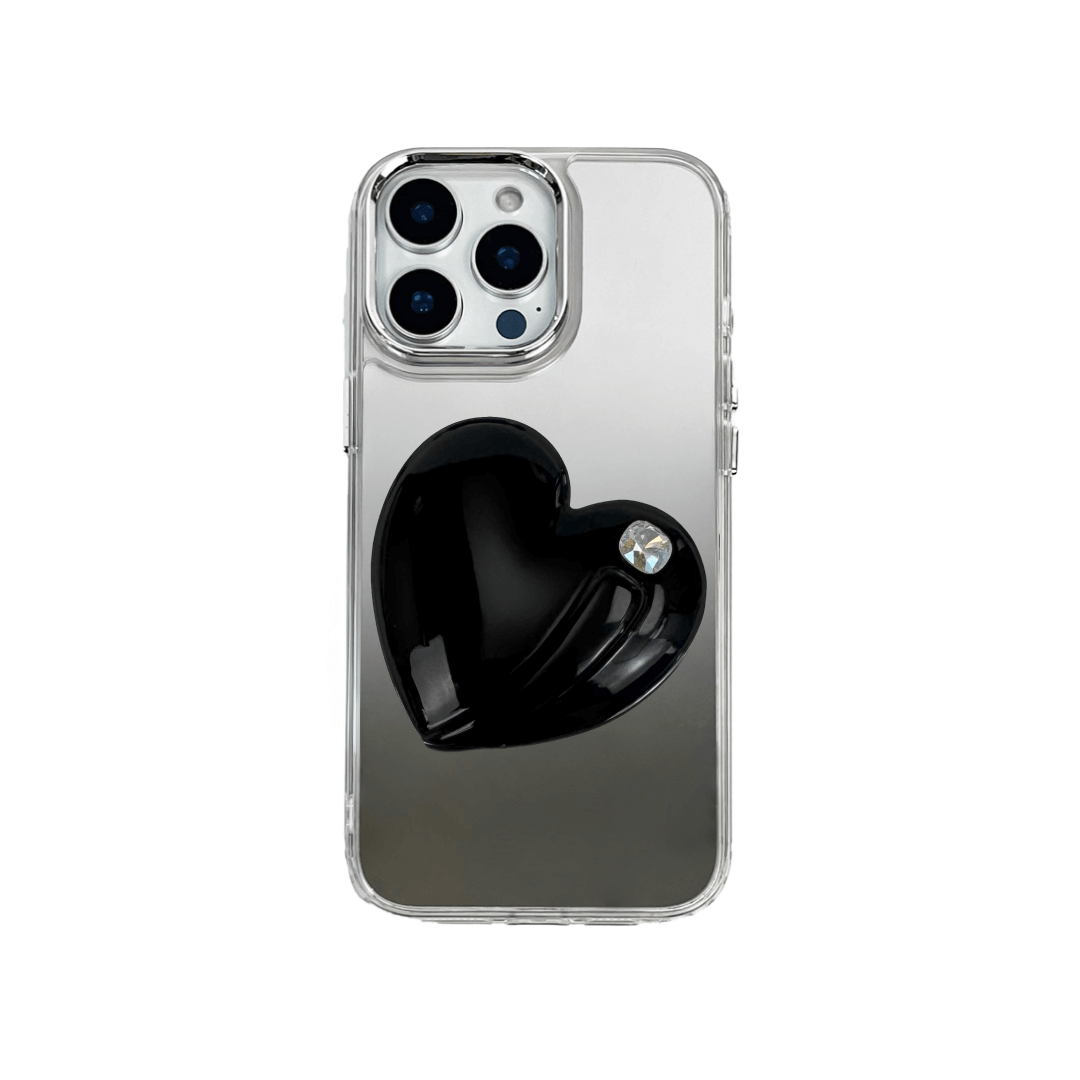 Metallic silver, pink, red, black iPhone case with a large sculpted heart in 3D, featuring a shiny chrome finish and a single gem-like detail.