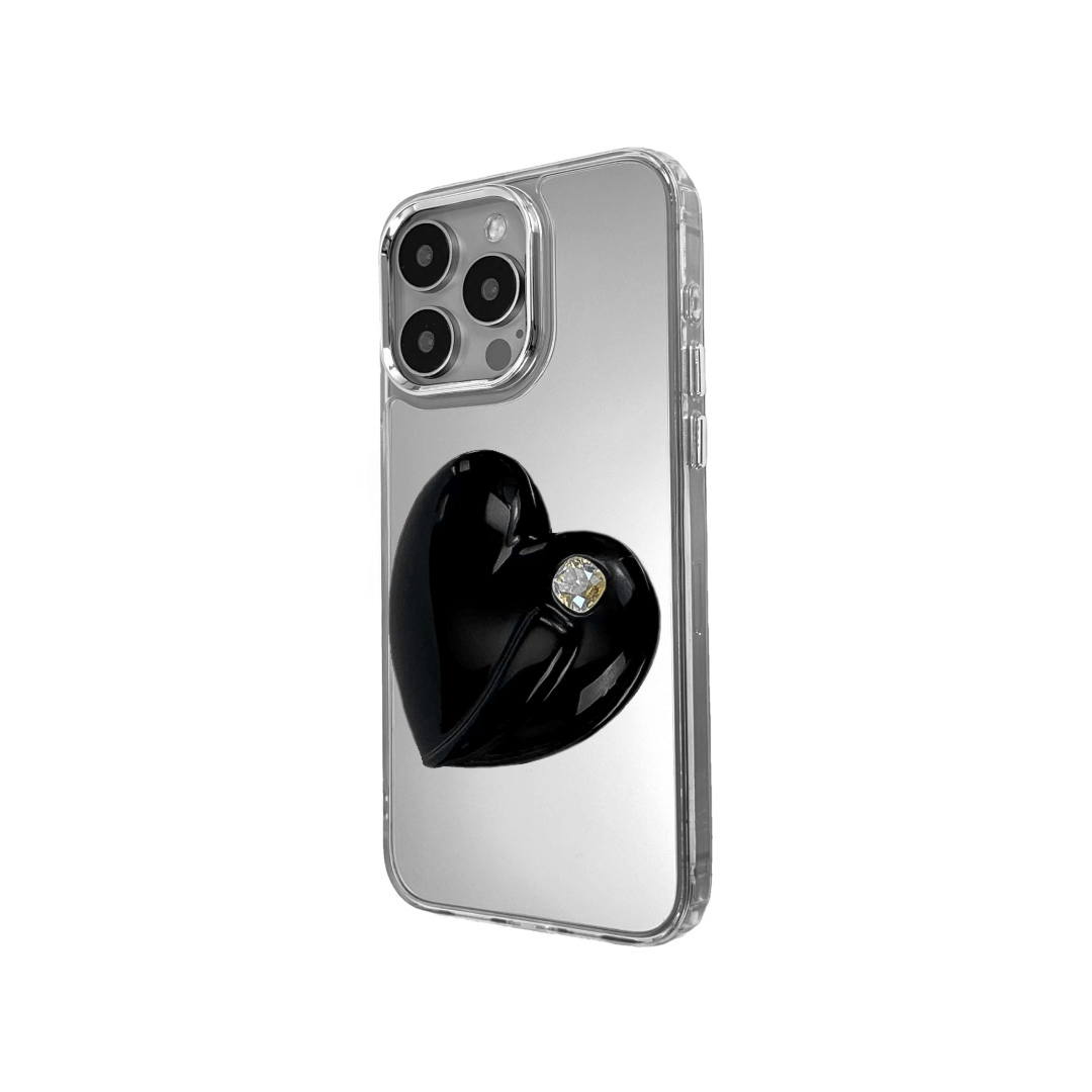 Metallic silver, pink, red, black iPhone case with a large sculpted heart in 3D, featuring a shiny chrome finish and a single gem-like detail.
