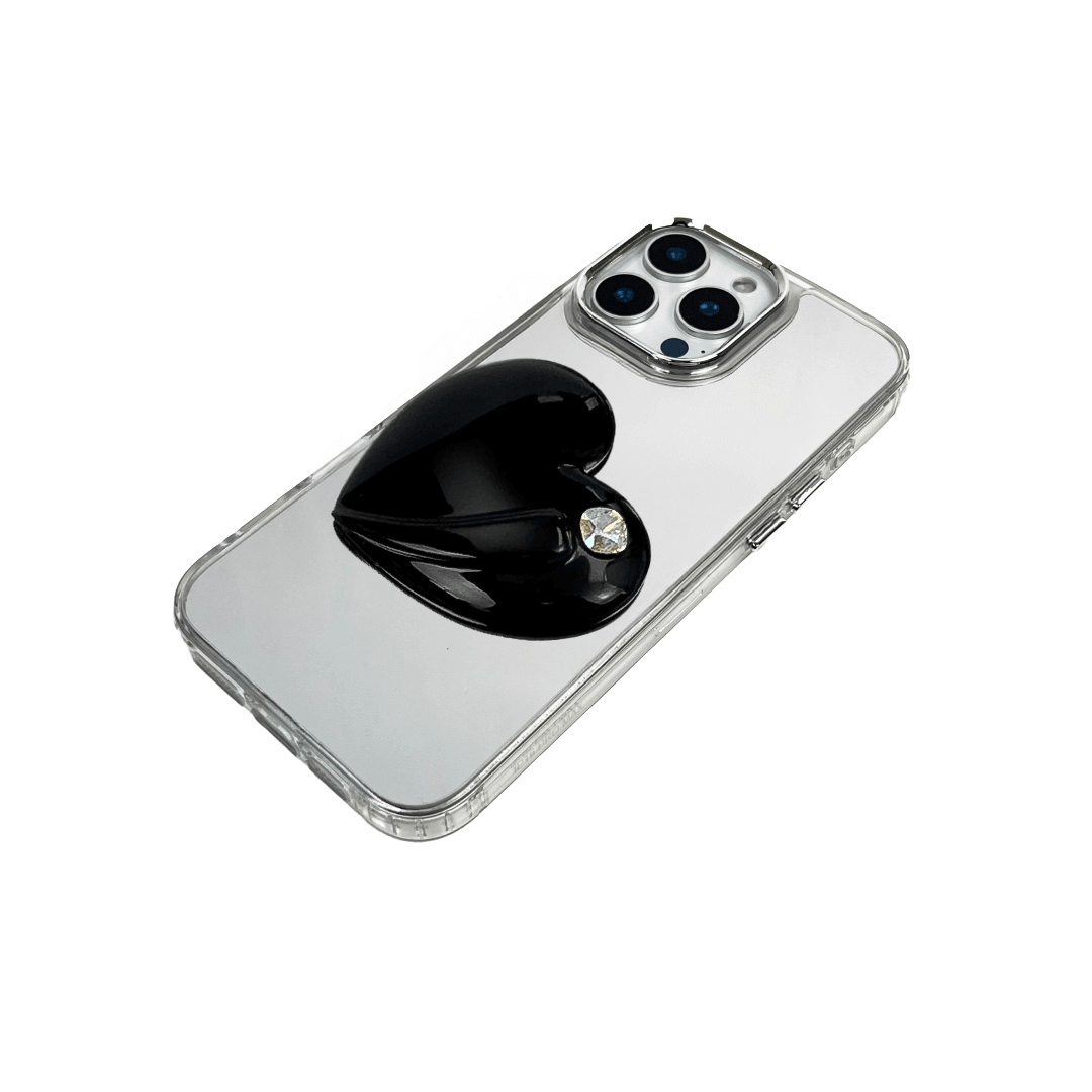 Metallic silver, pink, red, black iPhone case with a large sculpted heart in 3D, featuring a shiny chrome finish and a single gem-like detail.
