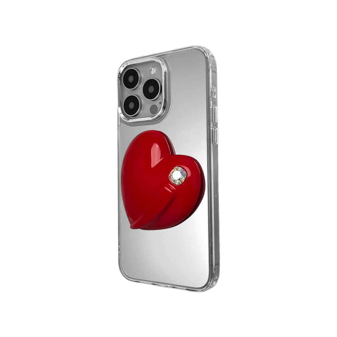 Metallic silver, pink, red, black iPhone case with a large sculpted heart in 3D, featuring a shiny chrome finish and a single gem-like detail.