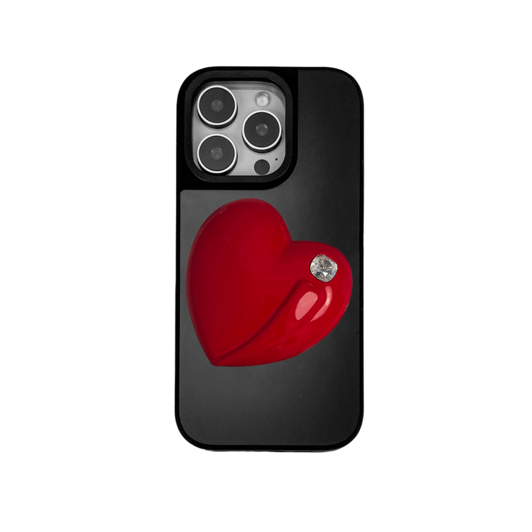 Metallic silver, pink, red, black iPhone case with a large sculpted heart in 3D, featuring a shiny chrome finish and a single gem-like detail.