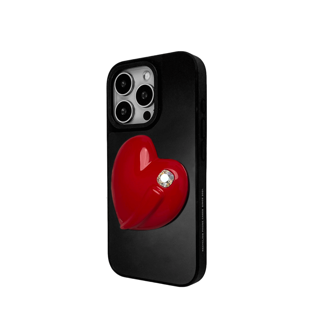Metallic silver, pink, red, black iPhone case with a large sculpted heart in 3D, featuring a shiny chrome finish and a single gem-like detail.