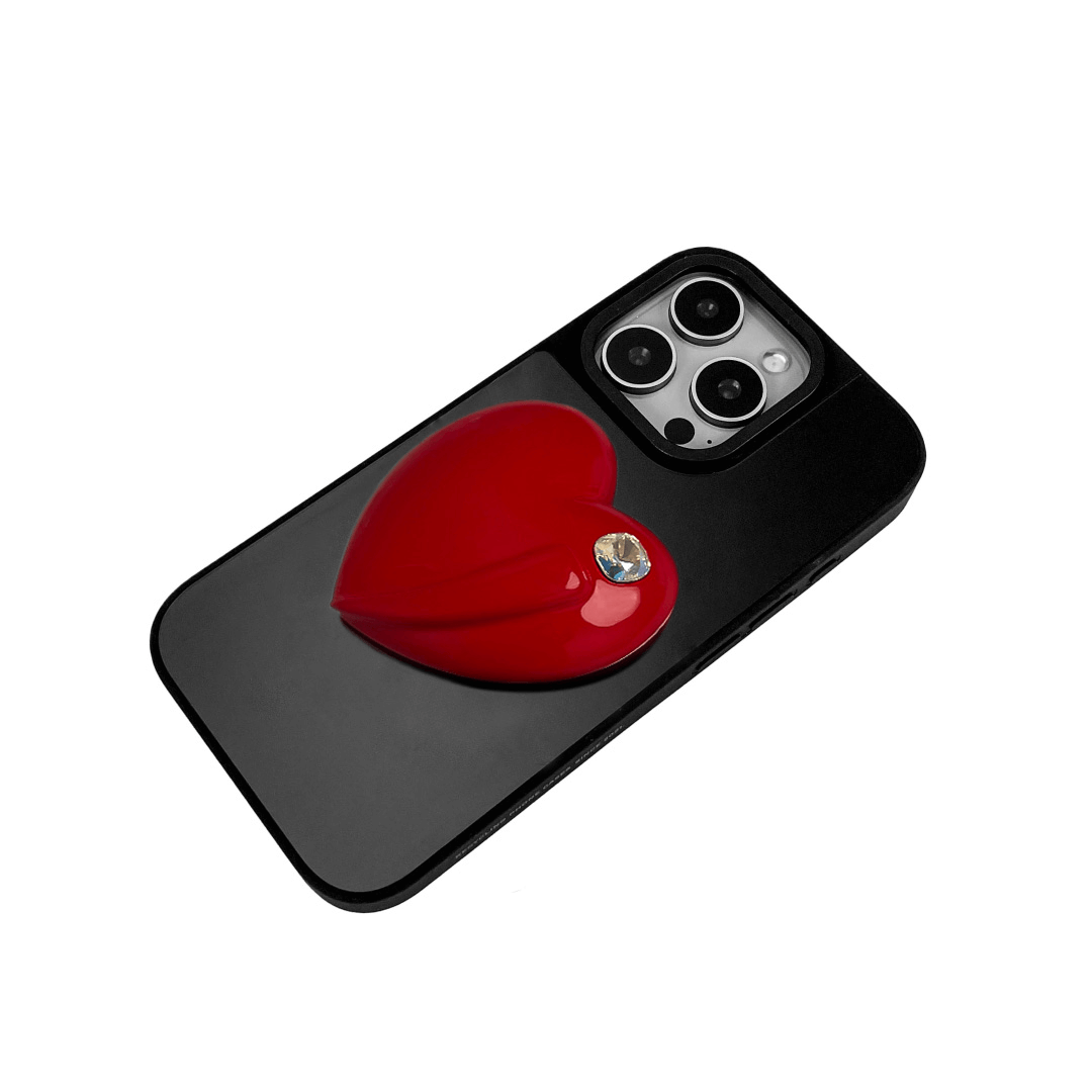 Metallic silver, pink, red, black iPhone case with a large sculpted heart in 3D, featuring a shiny chrome finish and a single gem-like detail.