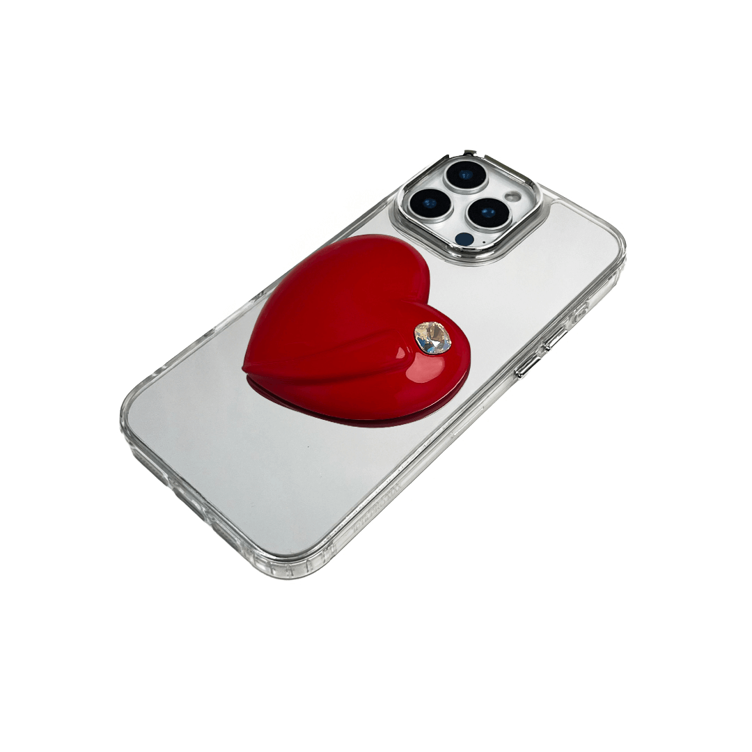 Metallic silver, pink, red, black iPhone case with a large sculpted heart in 3D, featuring a shiny chrome finish and a single gem-like detail.