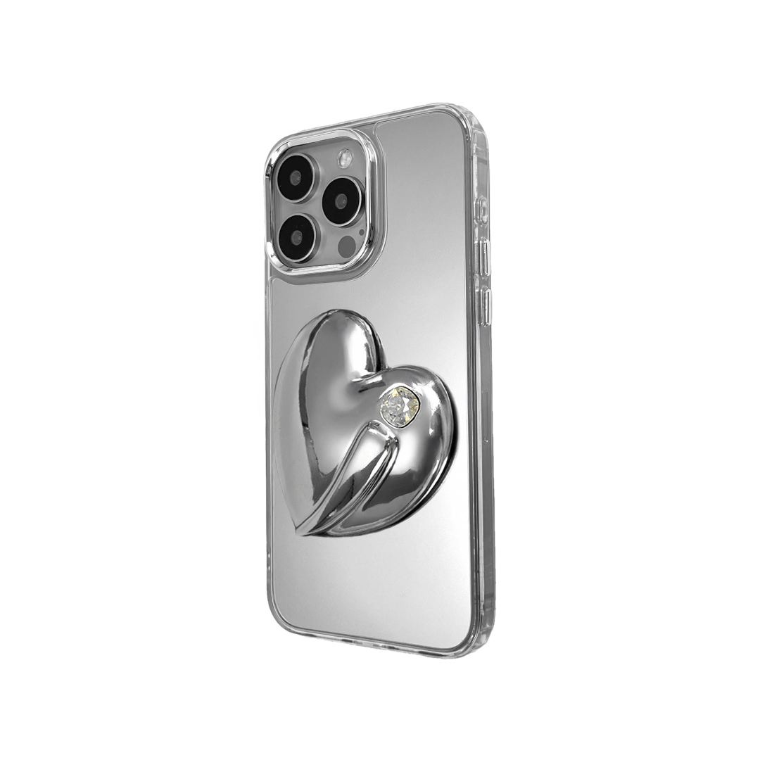 Metallic silver, pink, red, black iPhone case with a large sculpted heart in 3D, featuring a shiny chrome finish and a single gem-like detail.
