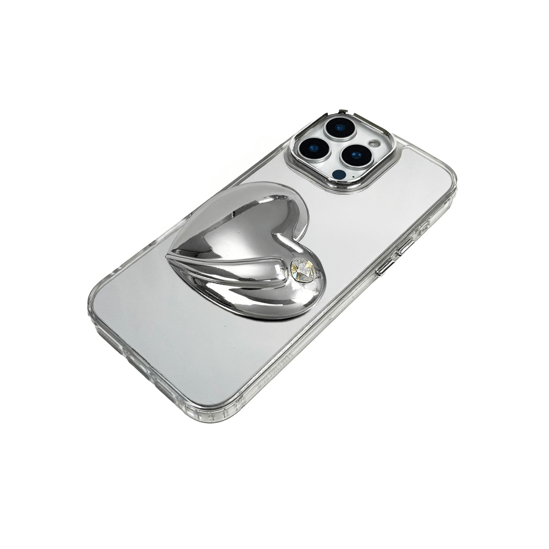 Metallic silver, pink, red, black iPhone case with a large sculpted heart in 3D, featuring a shiny chrome finish and a single gem-like detail.