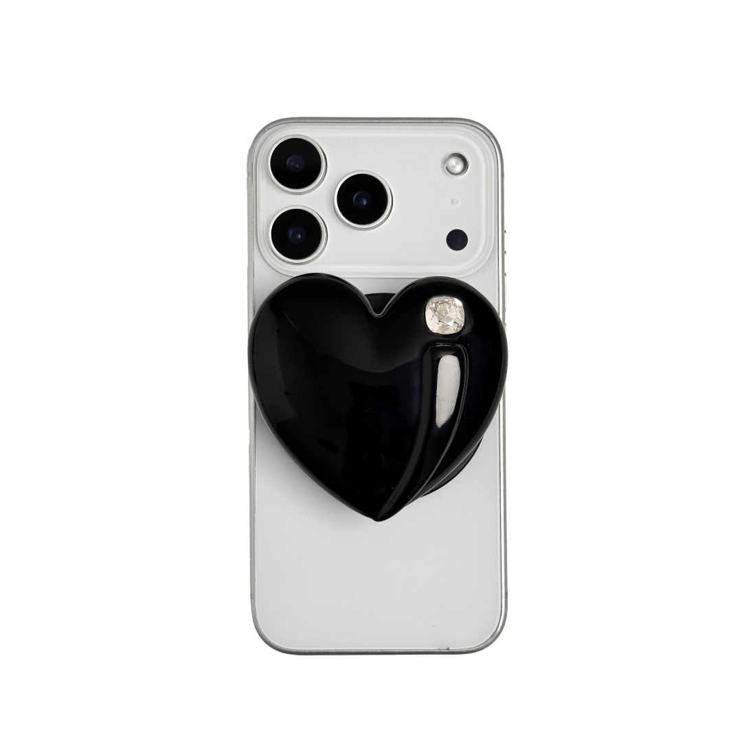 Metallic silver, pink, red, black Phone grip with a large sculpted heart in 3D, featuring a shiny chrome finish and a single gem-like detail.