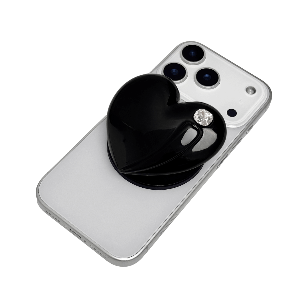 Metallic silver, pink, red, black Phone grip with a large sculpted heart in 3D, featuring a shiny chrome finish and a single gem-like detail.