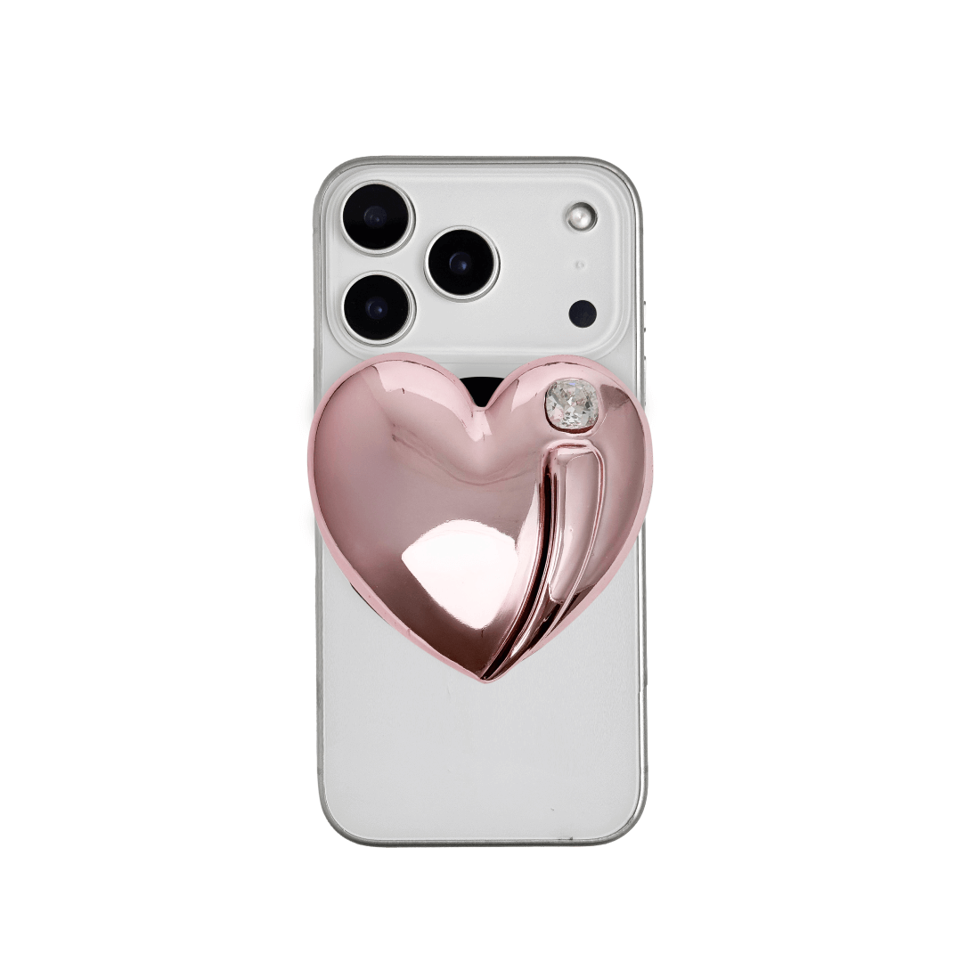 Metallic silver, pink, red, black Phone grip with a large sculpted heart in 3D, featuring a shiny chrome finish and a single gem-like detail.