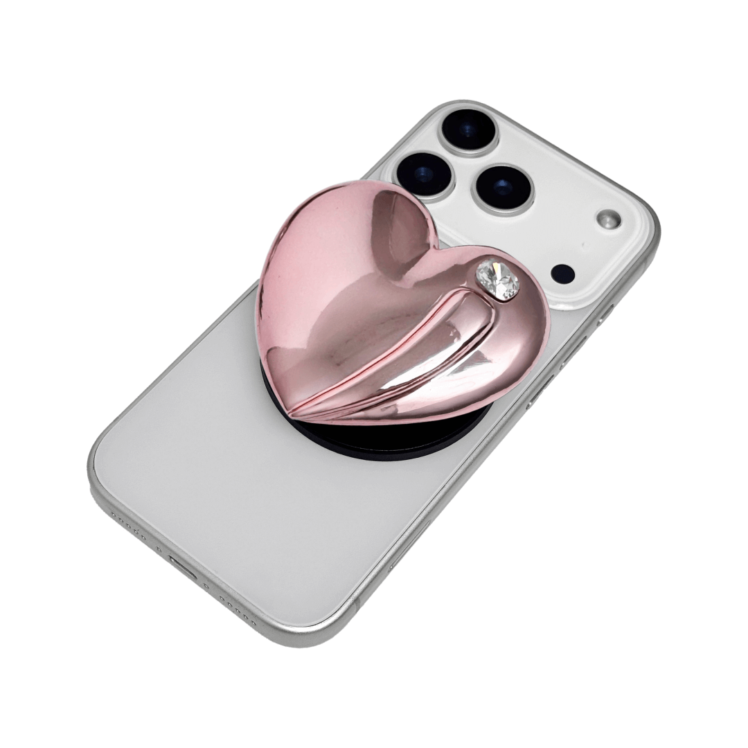 Metallic silver, pink, red, black Phone grip with a large sculpted heart in 3D, featuring a shiny chrome finish and a single gem-like detail.
