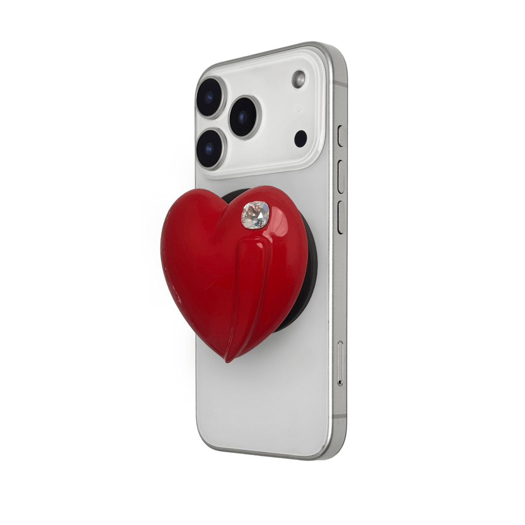 Metallic silver, pink, red, black Phone grip with a large sculpted heart in 3D, featuring a shiny chrome finish and a single gem-like detail.