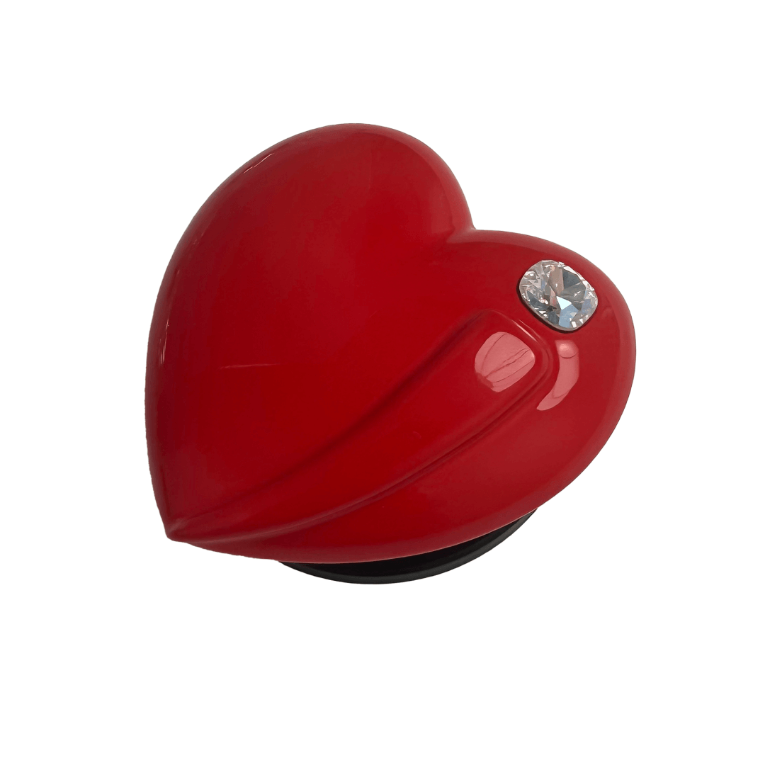 Metallic silver, pink, red, black Phone grip with a large sculpted heart in 3D, featuring a shiny chrome finish and a single gem-like detail.