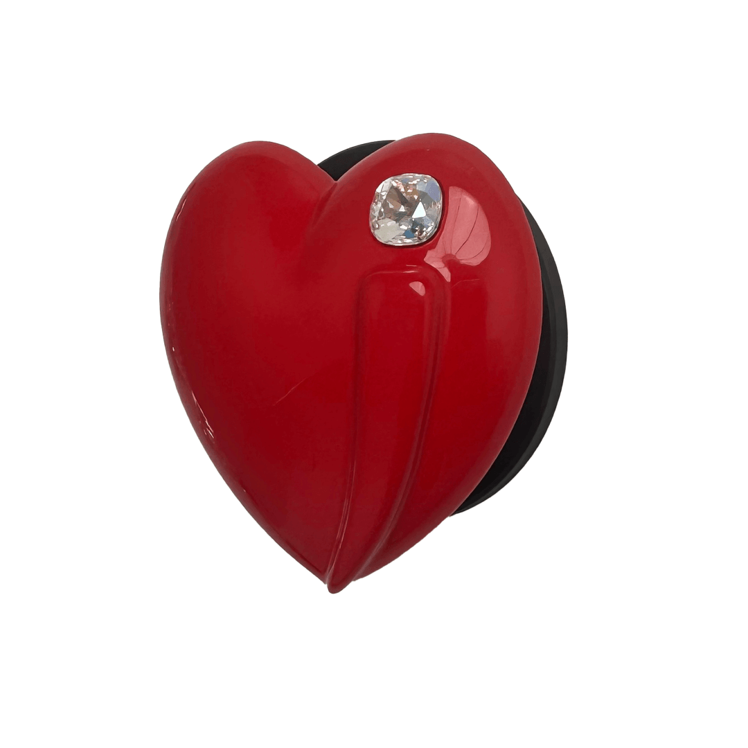 Metallic silver, pink, red, black Phone grip with a large sculpted heart in 3D, featuring a shiny chrome finish and a single gem-like detail.