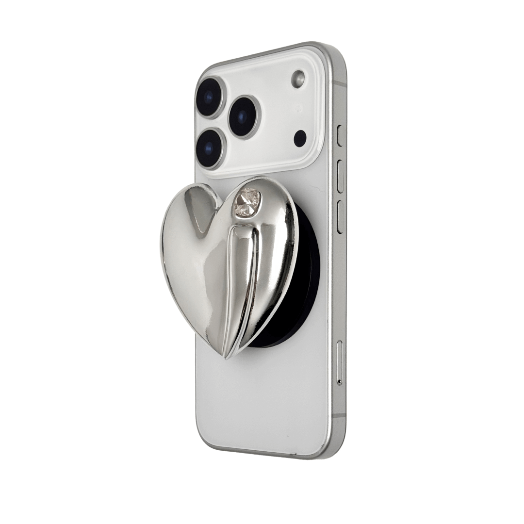 Metallic silver, pink, red, black Phone grip with a large sculpted heart in 3D, featuring a shiny chrome finish and a single gem-like detail.