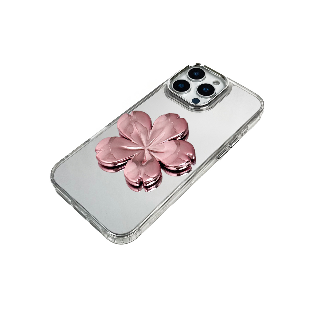 Silver mirror-finish iPhone case decorated with a pink and silver cherry blossom flower, combining a reflective modern surface with floral elegance.