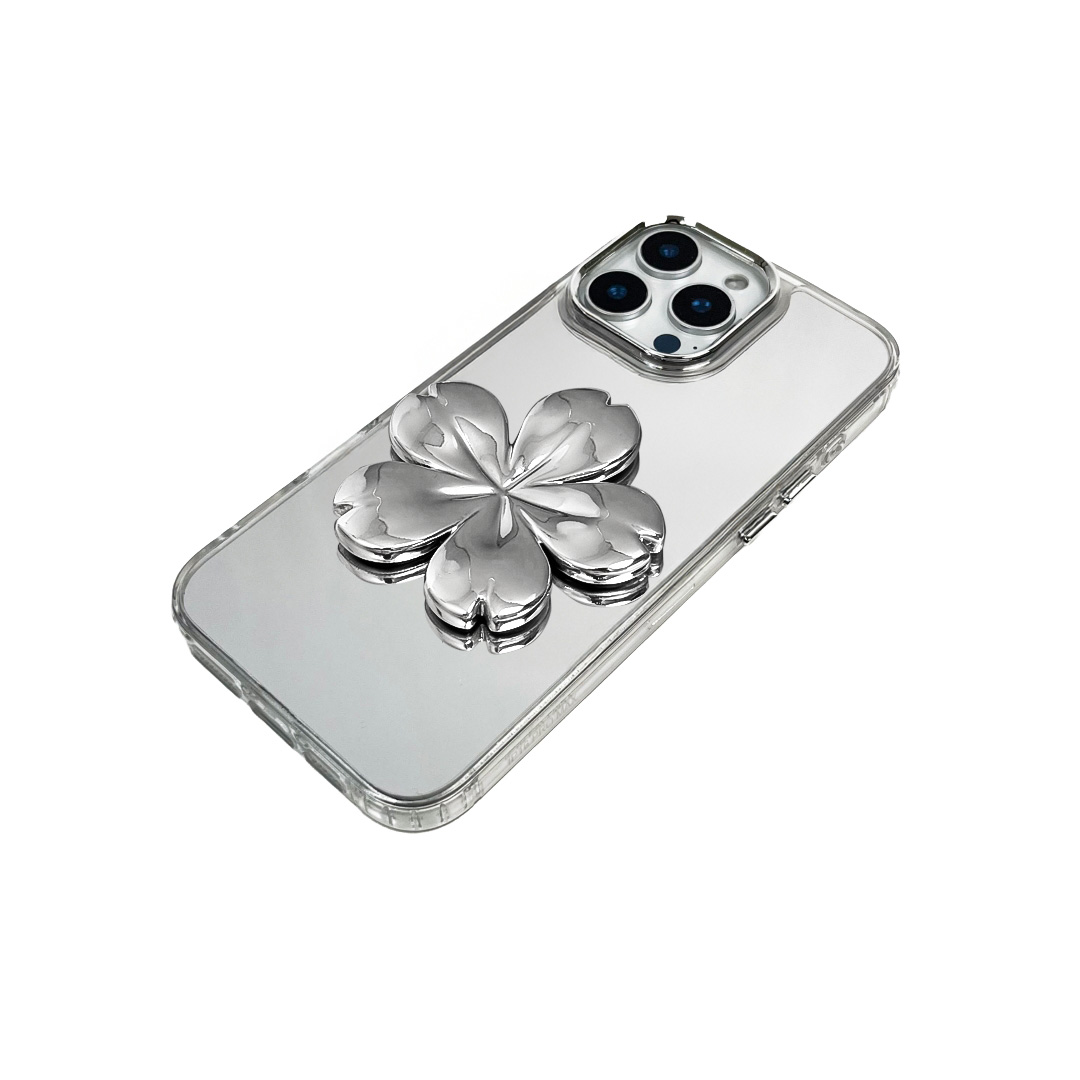 Silver mirror-finish iPhone case decorated with a pink and silver cherry blossom flower, combining a reflective modern surface with floral elegance.