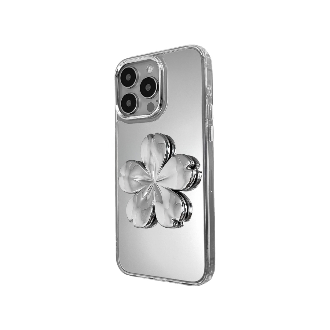 Silver mirror-finish iPhone case decorated with a pink and silver cherry blossom flower, combining a reflective modern surface with floral elegance.