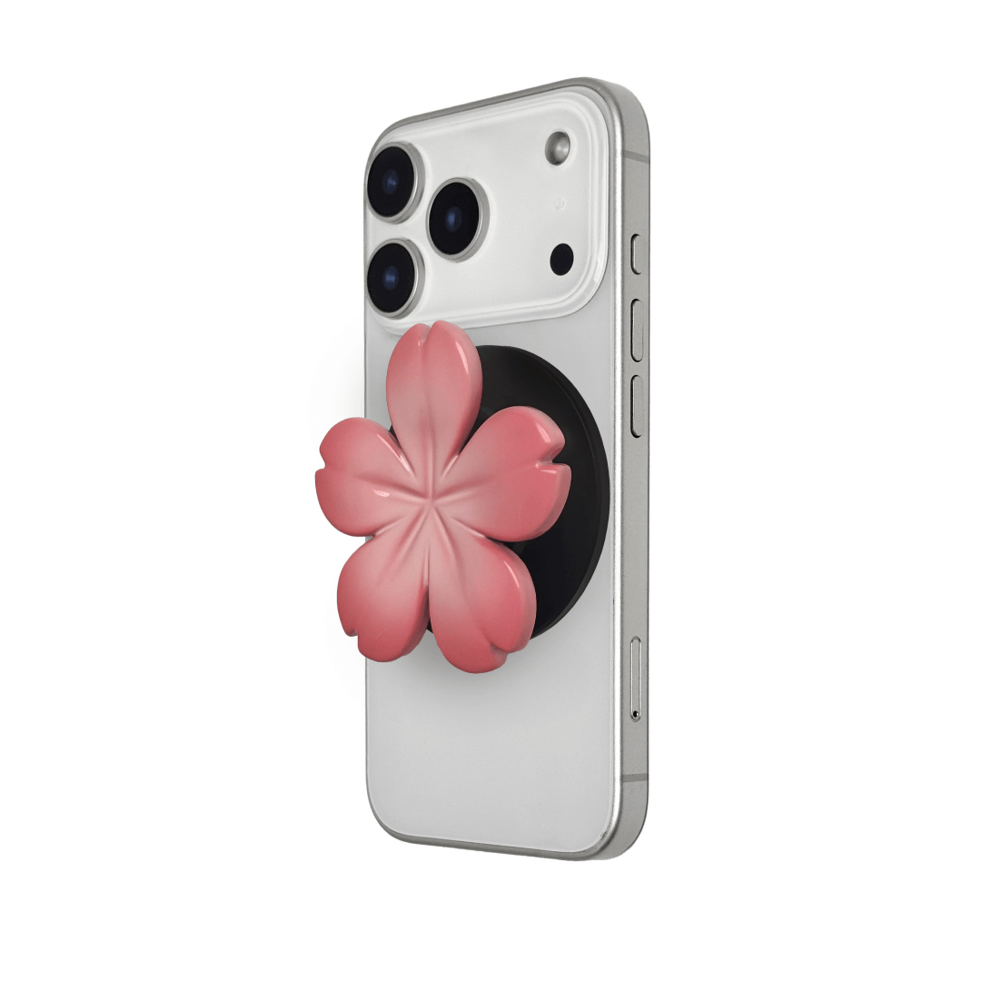 Magnetic phone grip with a silver mirror finish, decorated with a pink and silver cherry blossom flower for an elegant floral look.