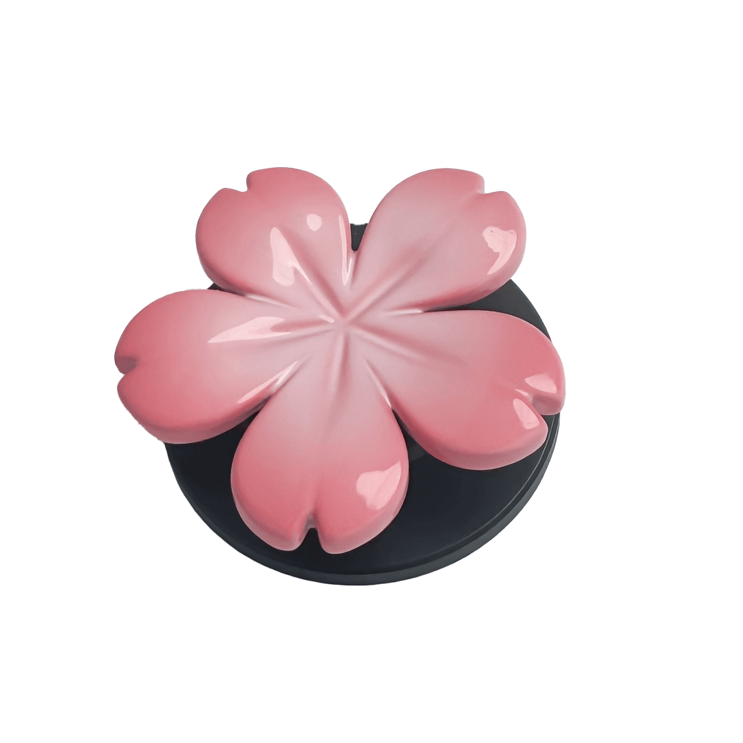 Magnetic phone grip with a silver mirror finish, decorated with a pink and silver cherry blossom flower for an elegant floral look.